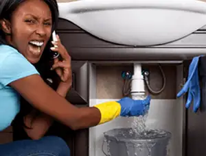 Emergency plumbing repair for a leaking sink drain under a bathroom vanity in Baltimore, MD