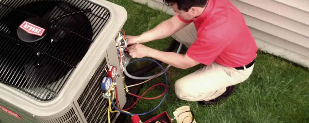 HVAC technician servicing an outdoor air conditioner unit in Baltimore, MD